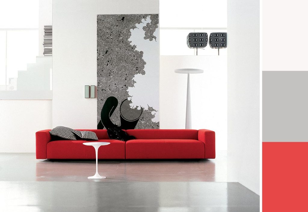 Paletta colori per arredare con un divano rosso e i toni del grigio.
